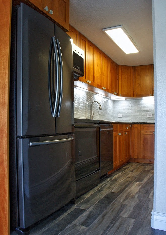 Napili Towers kitchen area with appliances, cabinets, and counters