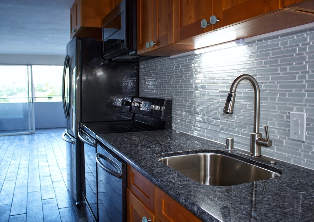 Napili Towers kitchen area with appliances, cabinets, and counters