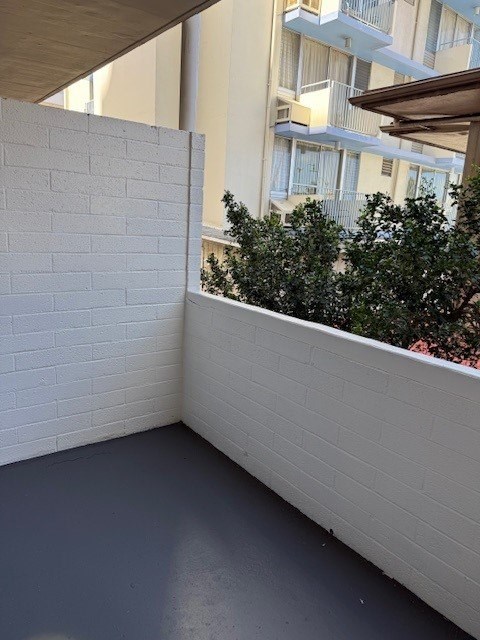 Pacific Oasis lanai/ balcony overlooking a building.
