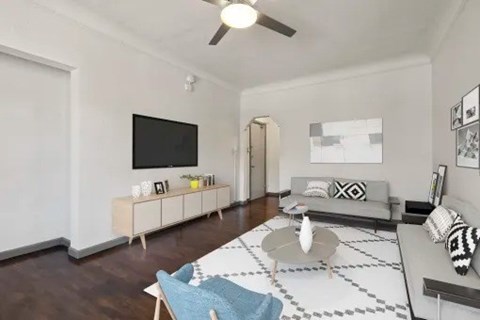 A living room with a grey sofa and a white coffee table.