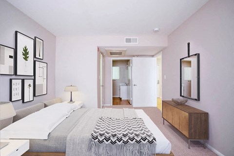 a bedroom with a bed and a dresser