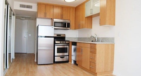 a kitchen with stainless steel appliances and wooden cabinets