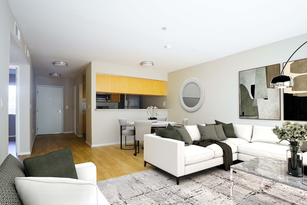 a living room and dining room with white furniture