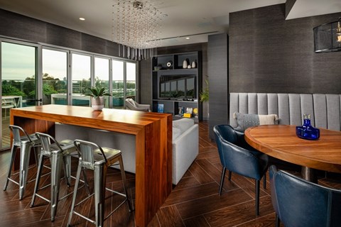 A modern dining room with a wooden table and chairs.