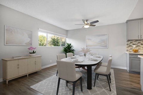 A dining room with a table set for four.