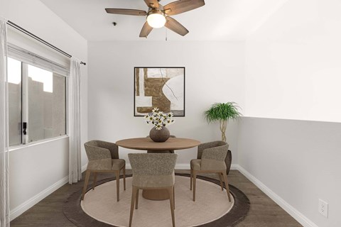 A dining room with a table and chairs.