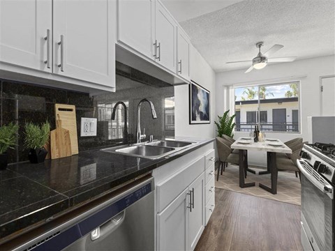 A modern kitchen with a dining table and chairs.
