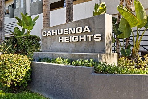 A sign that says Cahuenga Heights in front of a building.