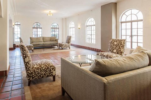 A living room with a couch, chairs, and a coffee table.