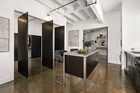 A black and white kitchen with a table and chairs.