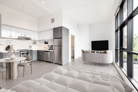 A modern kitchen with a dining table and chairs.