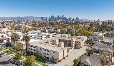 A view of a residential area with apartment buildings and palm trees.