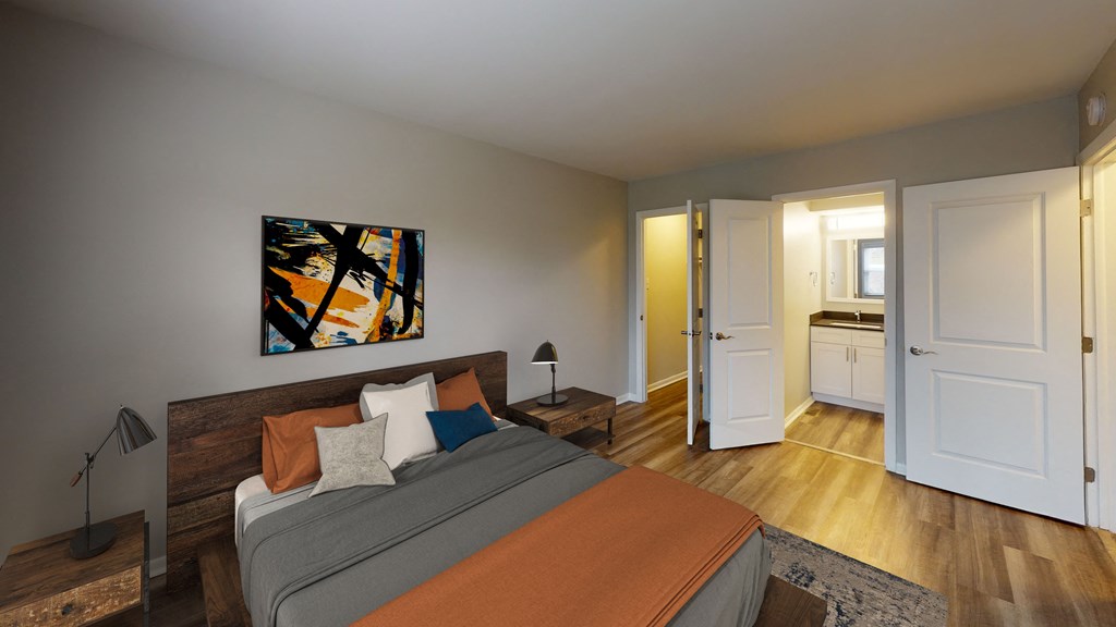 a bedroom with a bed and a door to a bathroom