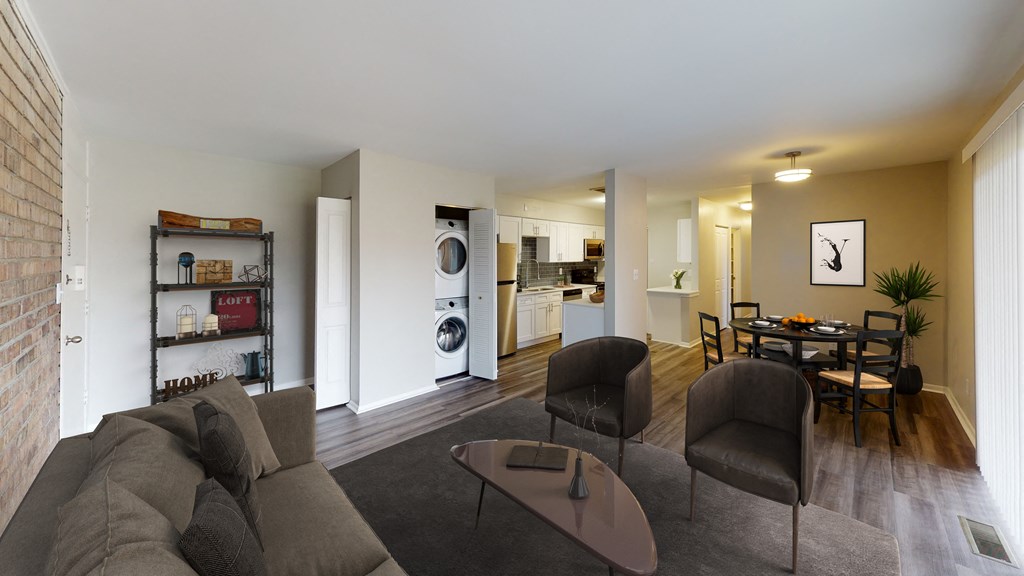 a living room with a couch and chairs and a dining room table