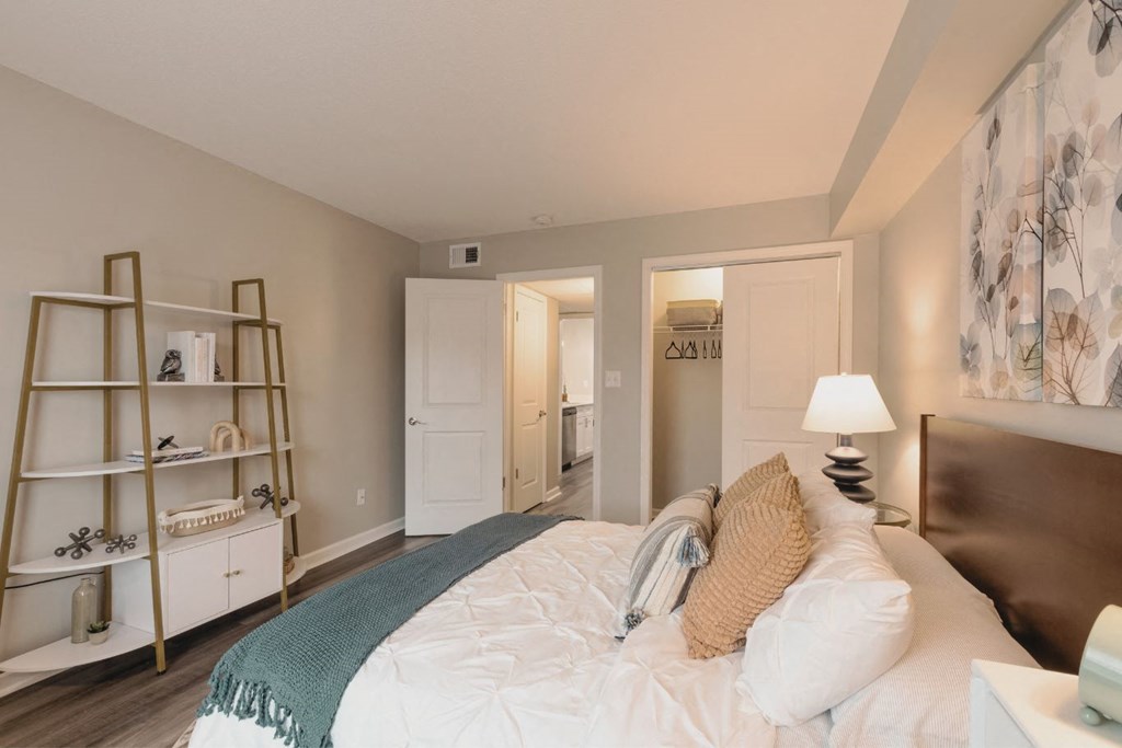 a bedroom with a bed and a bookshelf