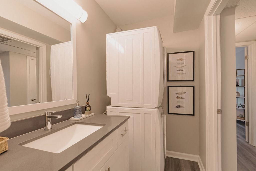 a bathroom with a sink and a refrigerator