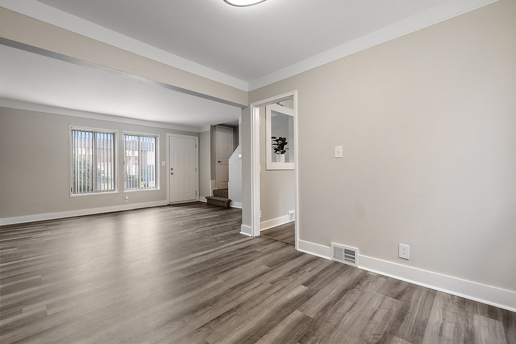 a bedroom with hardwood floors and grey walls