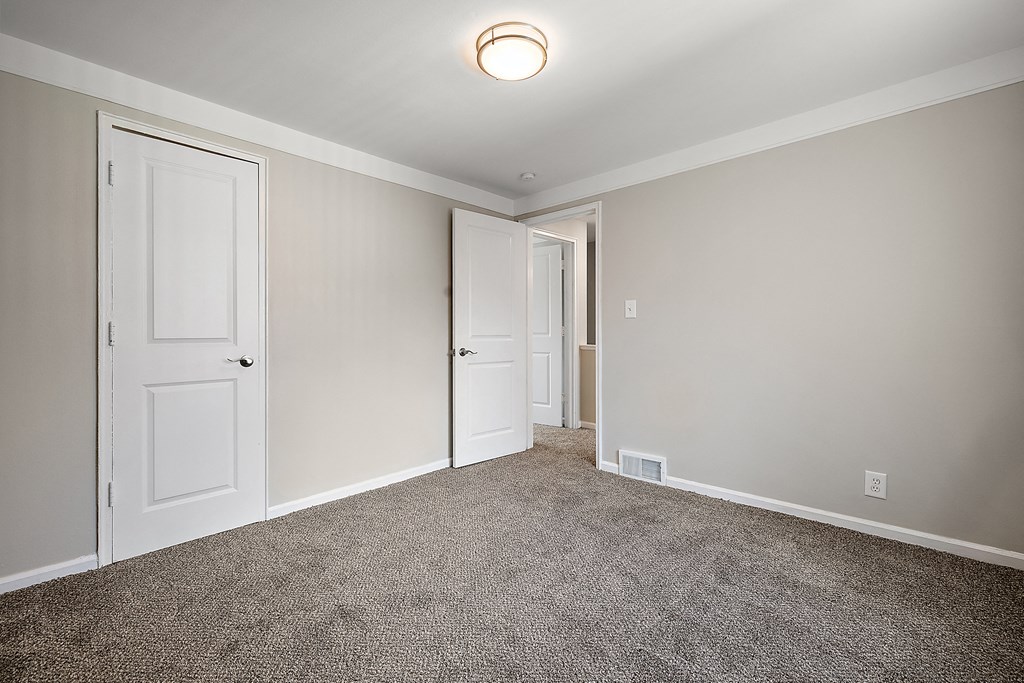 a bedroom with a carpeted floor