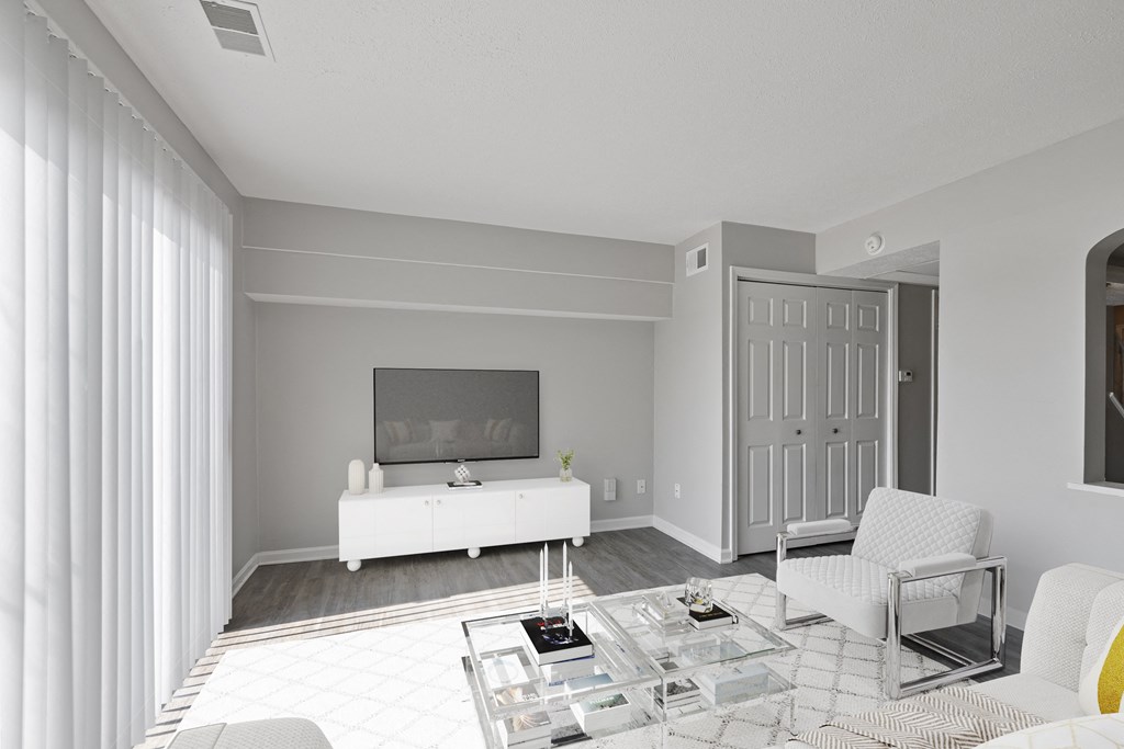 a living room with a white couch and a white coffee table