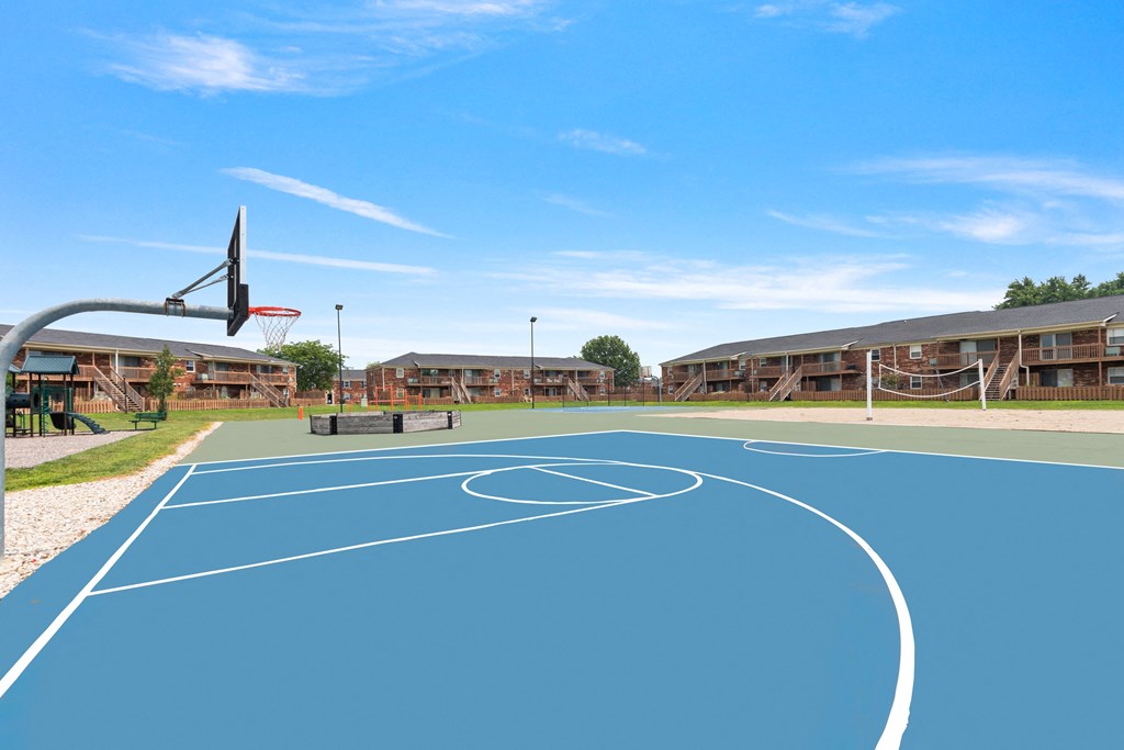 a basketball court with buildings in the background