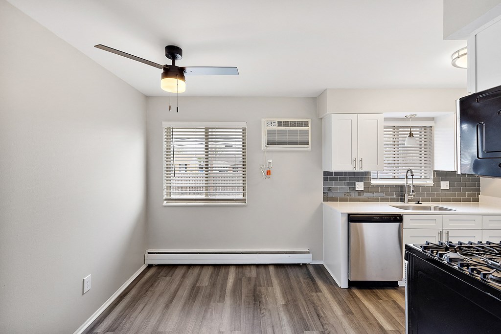 a kitchen with a stove top oven next to a window