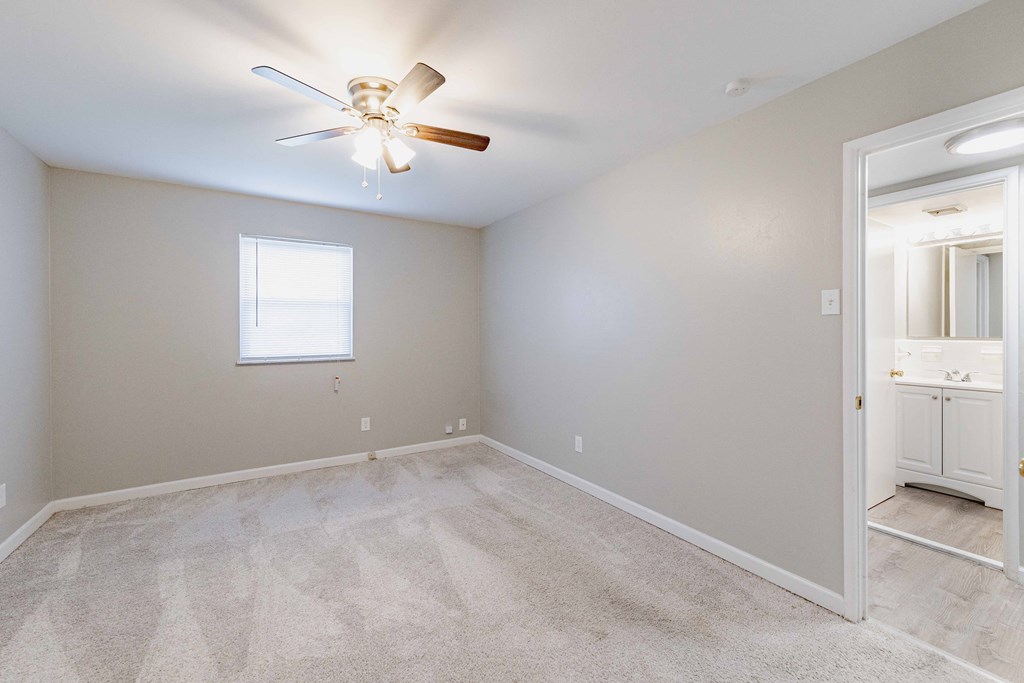 a bedroom with carpet and a ceiling fan