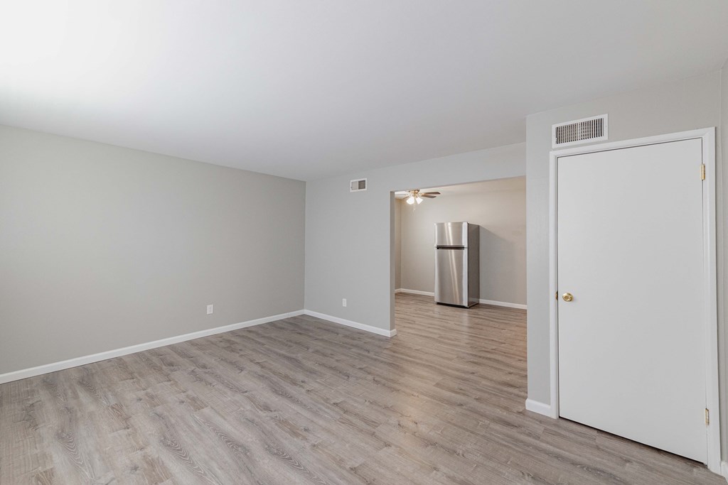 a bedroom with hardwood floors and grey walls