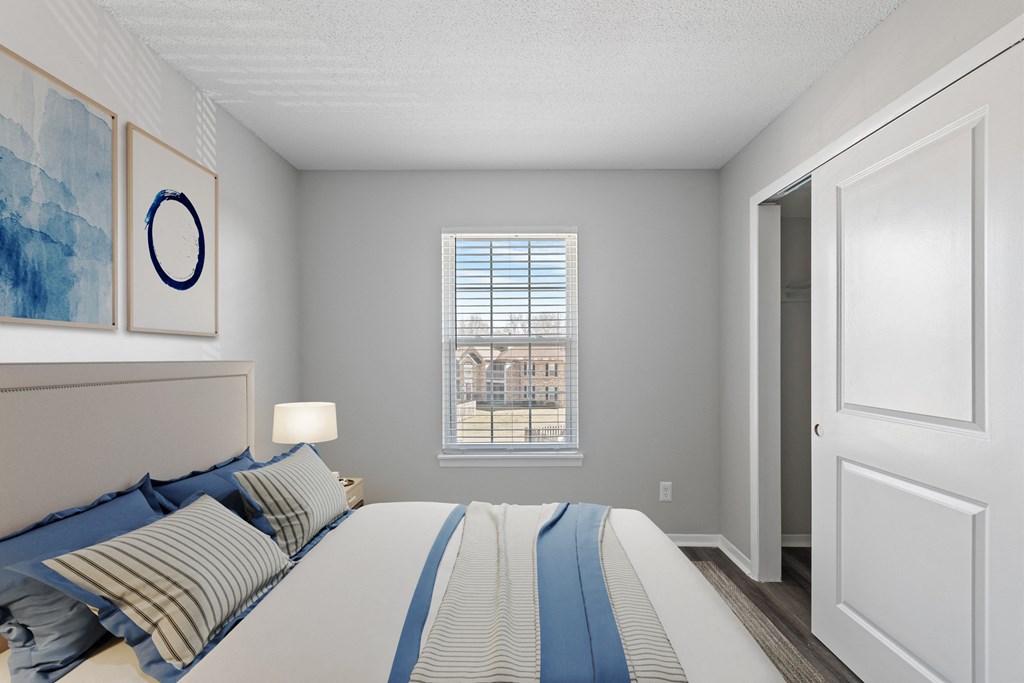 a bedroom with a large bed and a window