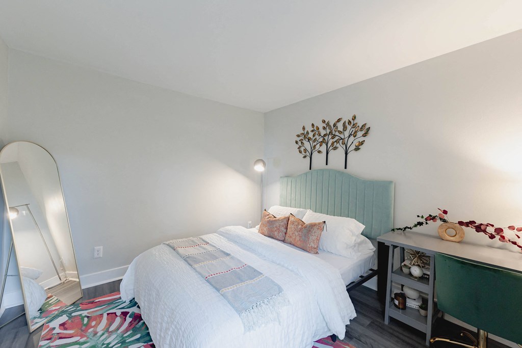 a bedroom with a white bed and a green headboard