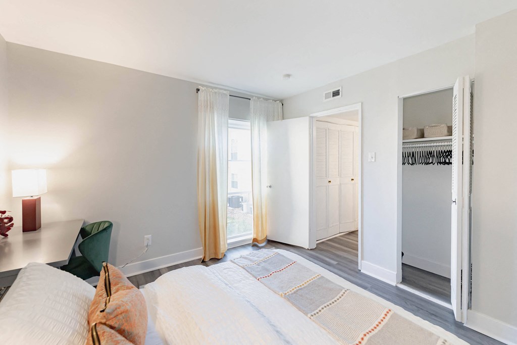 a bedroom with a large bed and a door to a closet