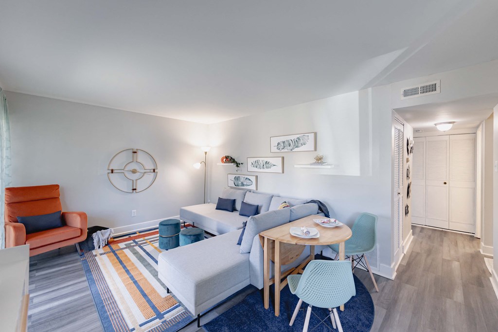 a living room with a white couch and a table with chairs