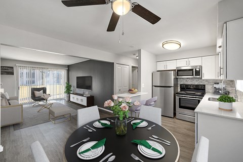 a living room and kitchen with a black dining table