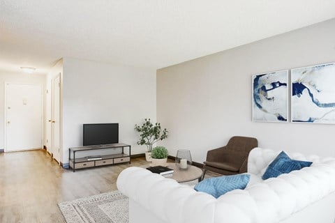 a living room with a white couch and a tv