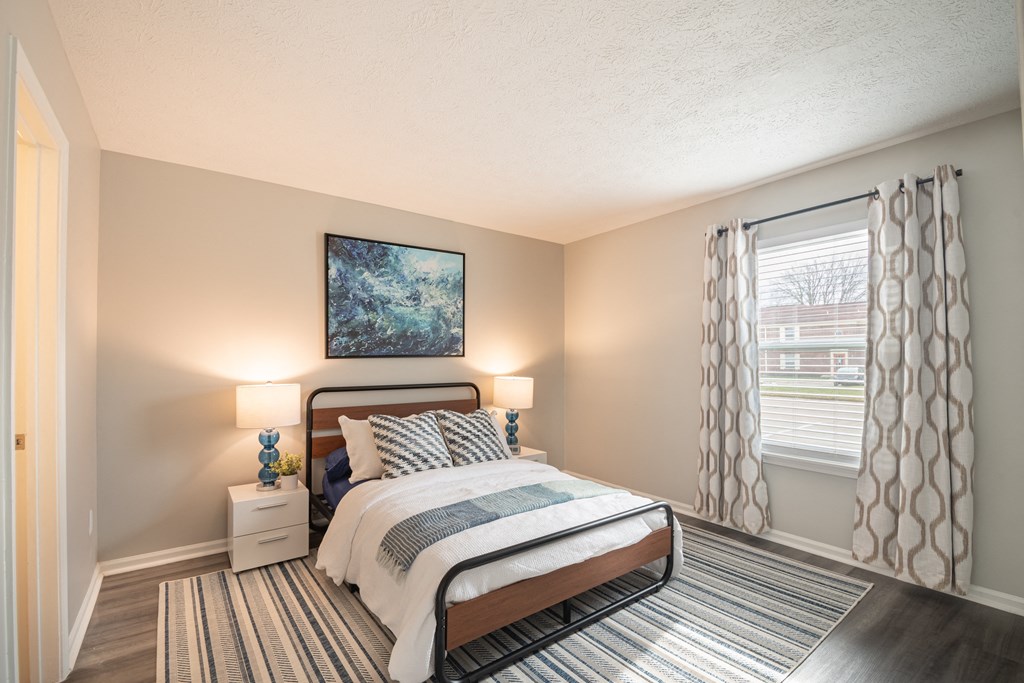 a bedroom with a bed and two nightstands