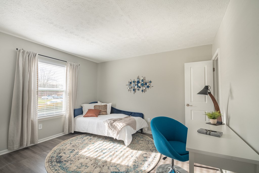 a bedroom with a bed and desk in a 555 waverly unit