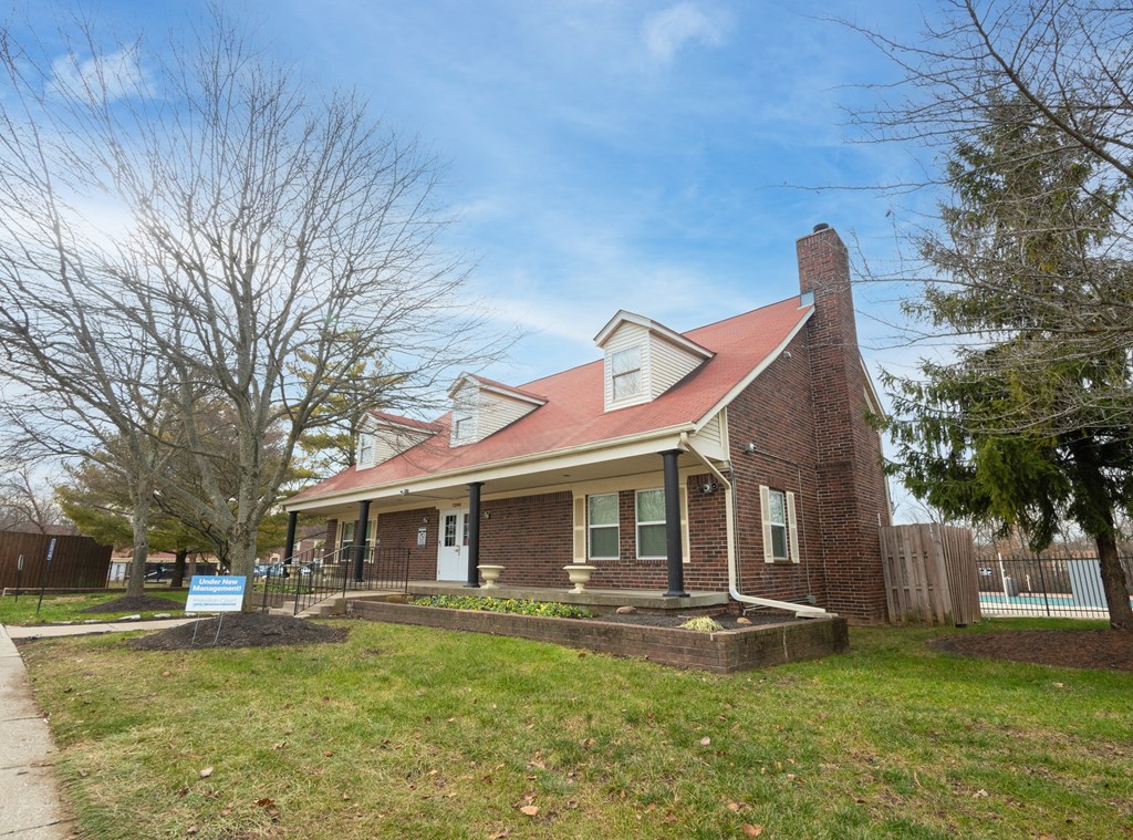 an old brick house with a red roof