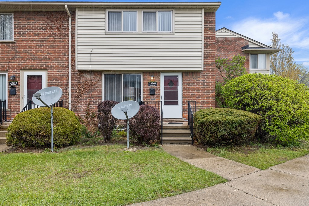 a house with two satellite dishes in front of it
