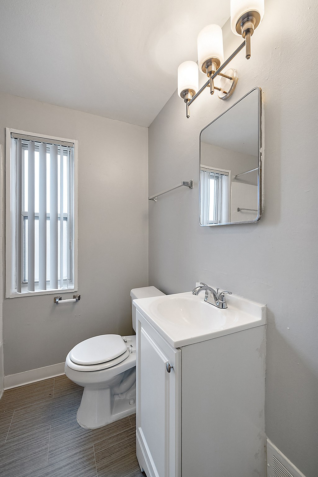 a small bathroom with a toilet sink and mirror