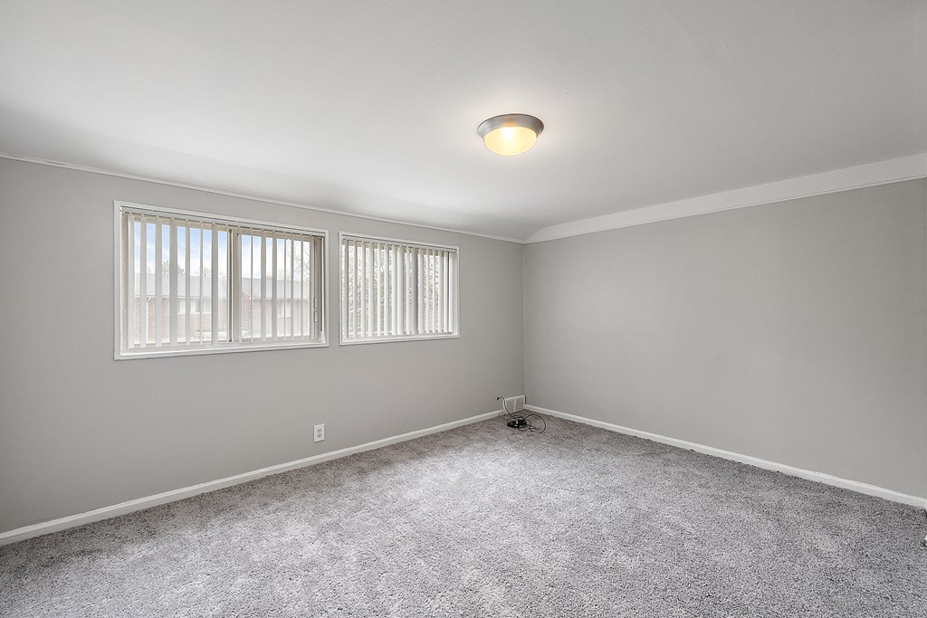 a bedroom with gray walls and white trim