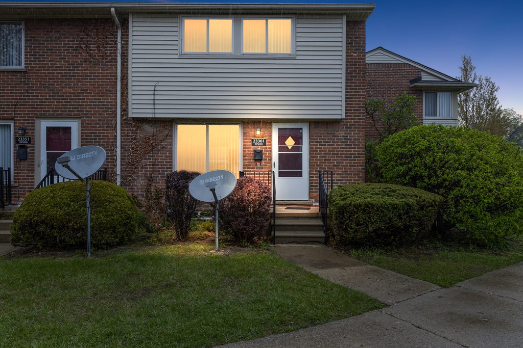 a house with two satellite dishes in front of it