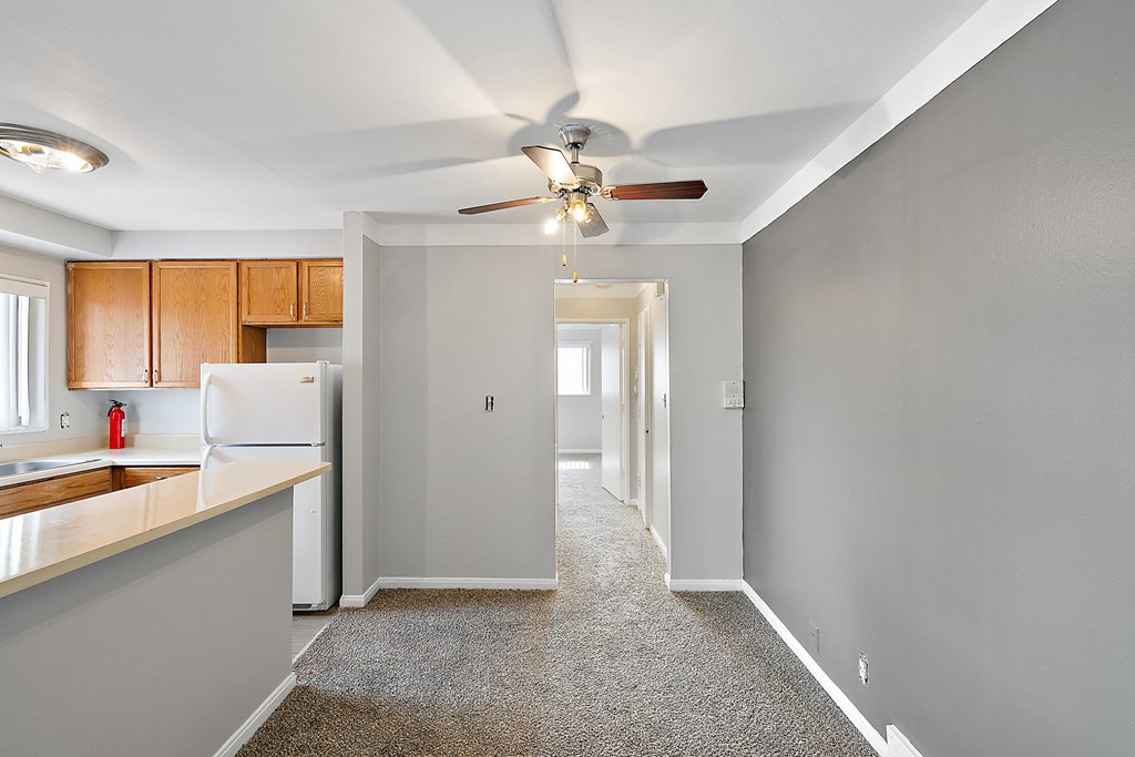 a kitchen with a white refrigerator freezer next to a white stove top oven