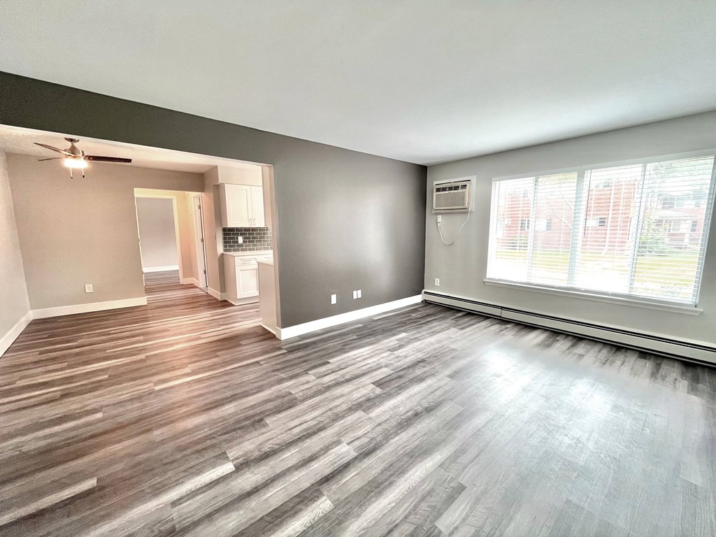 an empty living room with a large window