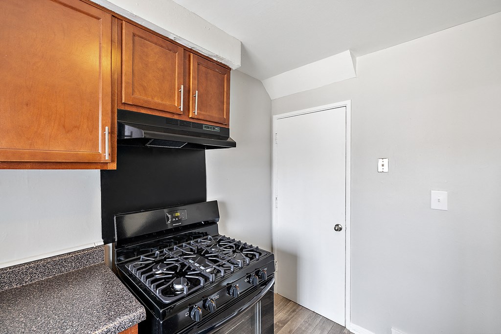 a kitchen with a stove and cabinets