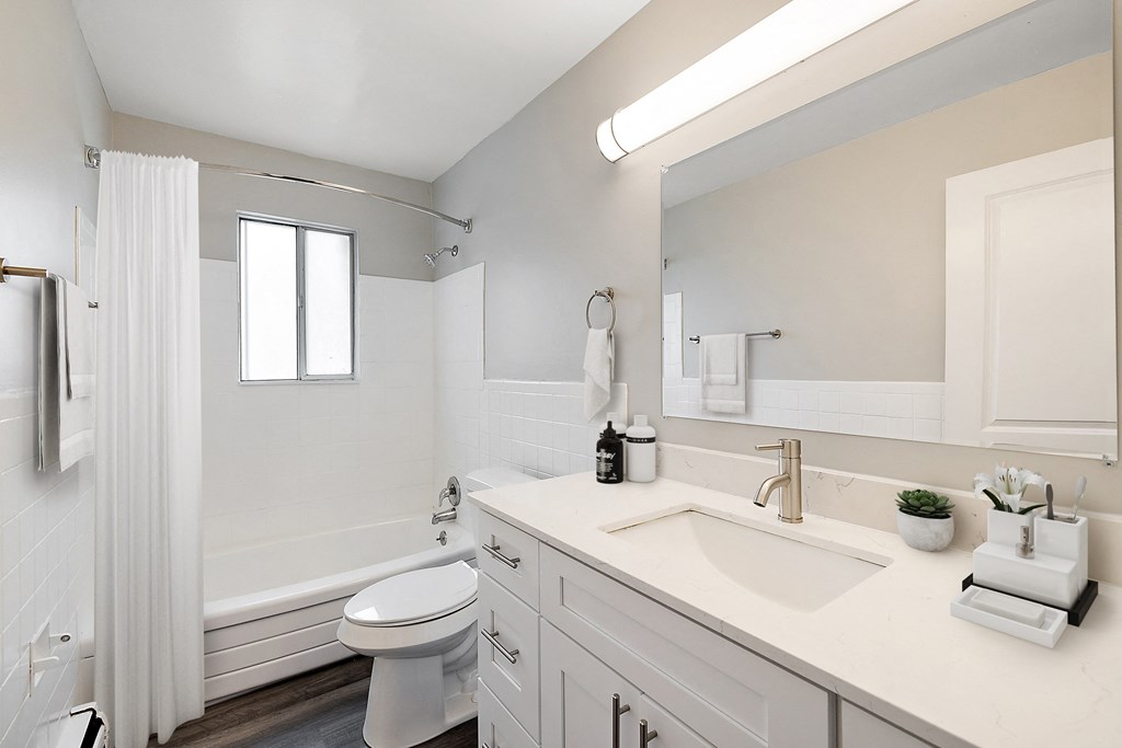 a bathroom with a white countertop and a white bathtub