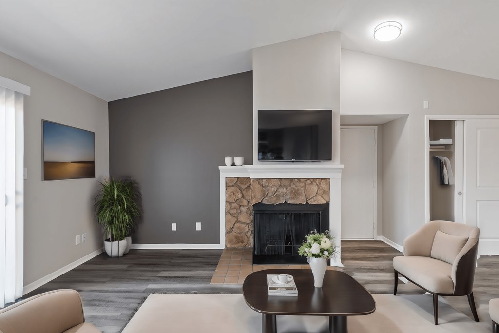 a living room with a fireplace and a tv on the wall