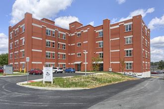 Mount Joy Senior Housing | a large red building with a parking lot in front of it