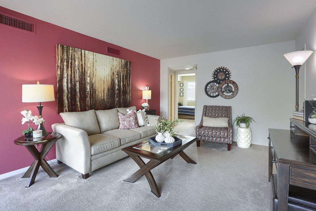a living room with a couch chair and coffee table