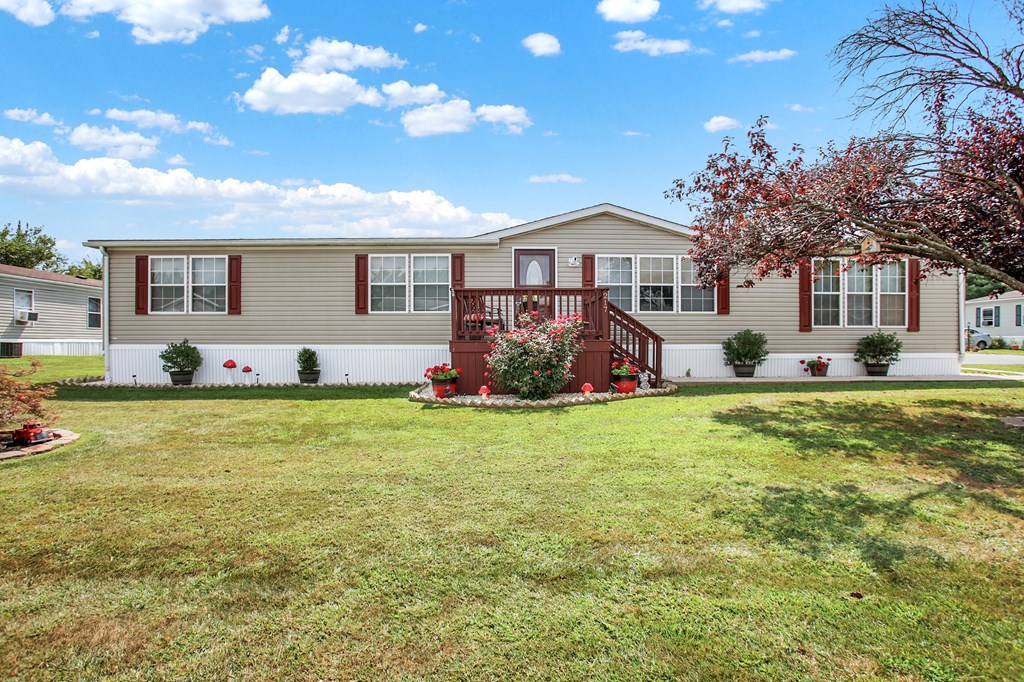 a home with a large lawn in front of it