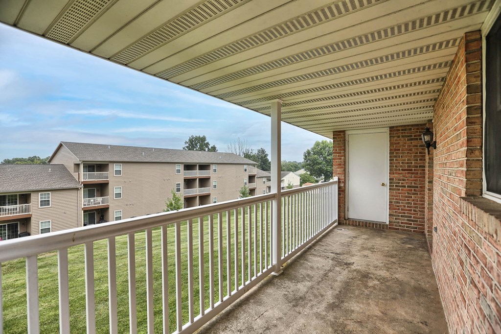 the view from the balcony of an apartment building with a white railing