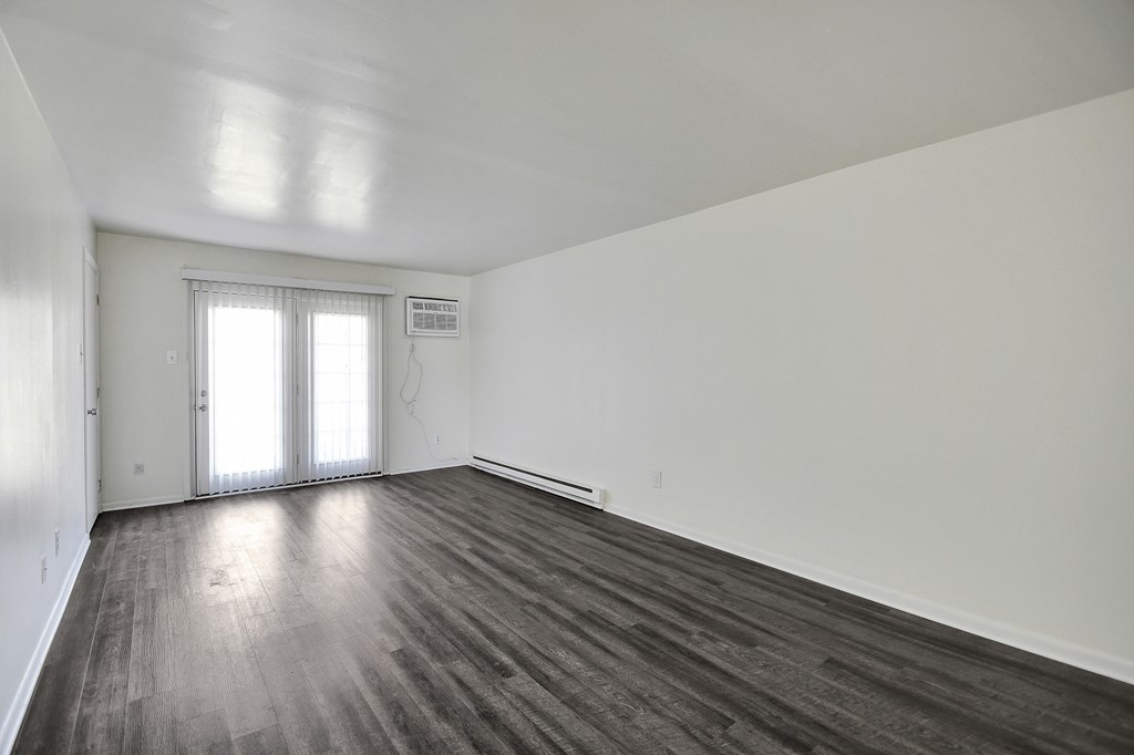 A room with wooden floors and white walls.